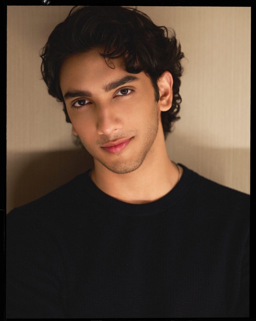 Vedang Raina in a formal black suit posing at a Bollywood Hungama photoshoot
