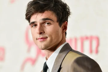 Jacob Elordi portrait in a neutral background wearing a classic suit. Jacob Elordi movies and tv shows